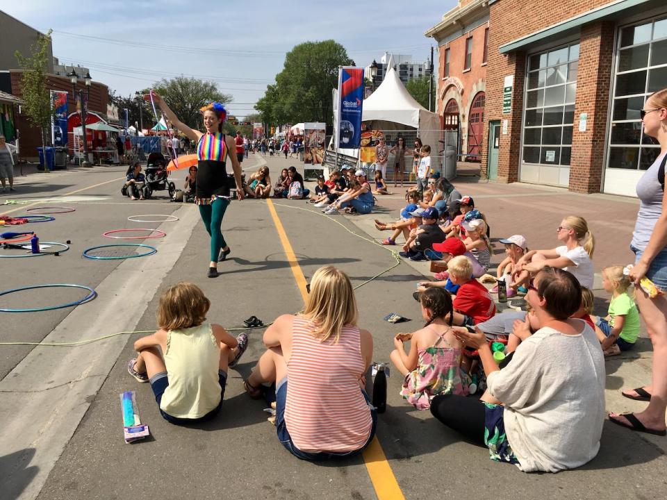 Crowds gather for the street performances at the Edmonton International Fringe Theatre Festival. The festival is struggling financially and considering scaling back its programming this year.