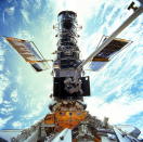 NASA astronauts John Grunsfeld and Steven Smith work to upgrade the Hubble Space Telescope during the STS-103 servicing mission to the observatory in December 1999. NASA has flown five servicing missions to repair and upgrade Hubble during its