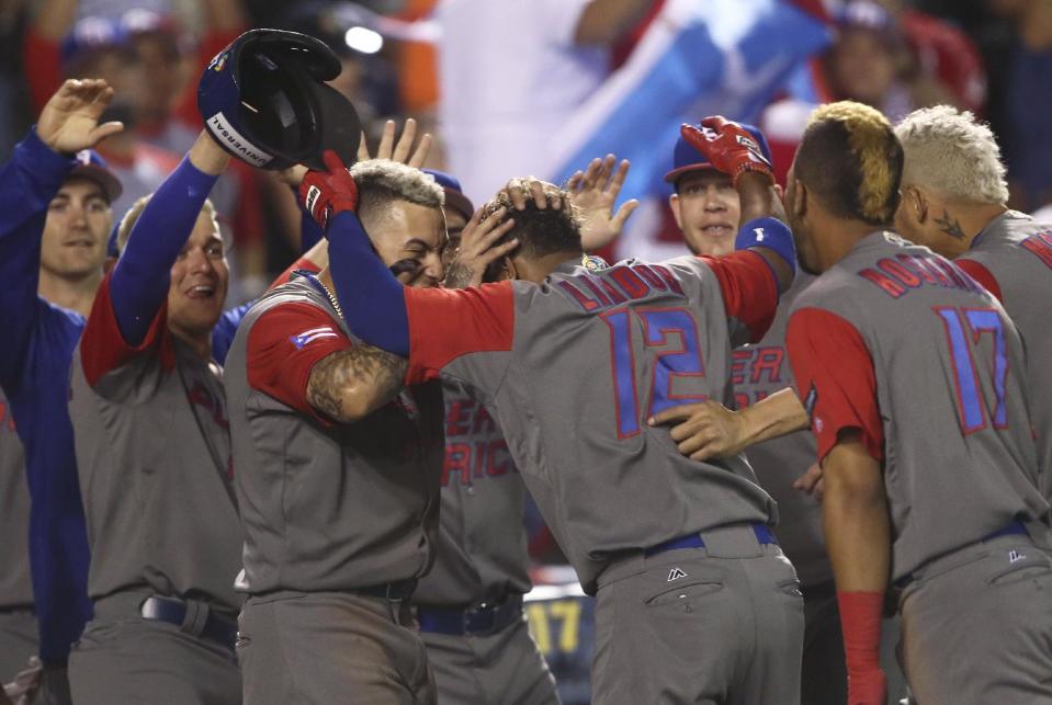 Puerto Rico's Francisco Lindor, celebrates with his teammates after a home run during a World Baseball Classic game against Mexico, in Guadalajara, Mexico, Saturday, March 11, 2017. (AP Photo/Luis Gutierrez)