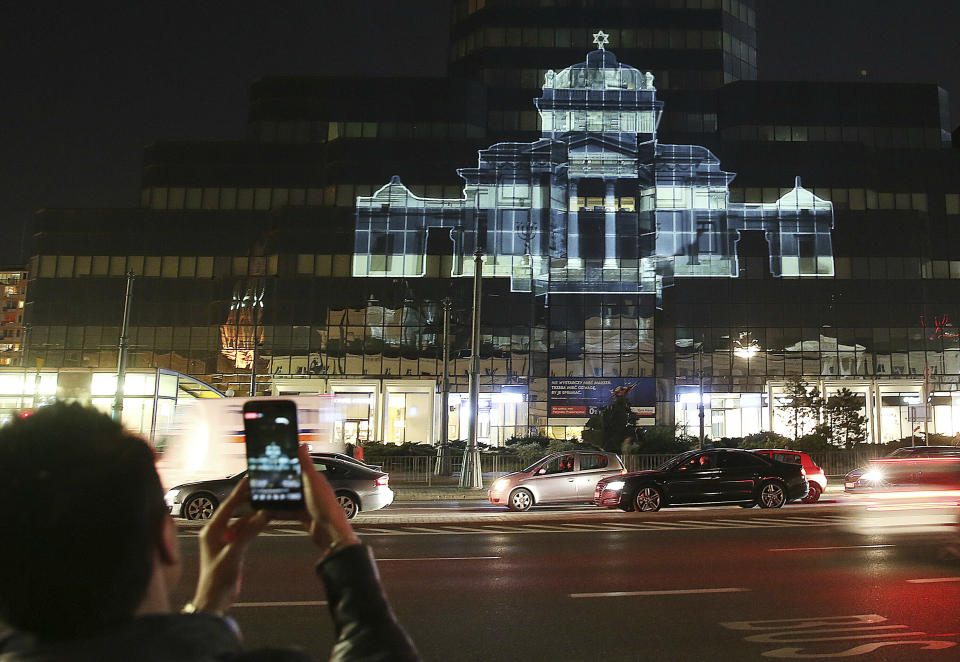 The Great Synagogue of Warsaw, which was destroyed by the German forces during World War II, was recreated virtually with light as part of anniversary commemorations of the 1943 uprising in the Warsaw Ghetto, in Warsaw, Poland, Thursday, April 18, 2019. The multimedia installation, which included the archival recordings of a prewar cantor killed in the Holocaust, is the work of Polish artist Gabi von Seltmann. It was organized by a group that fights anti-Semitism.(AP Photo/Czarek Sokolowski)