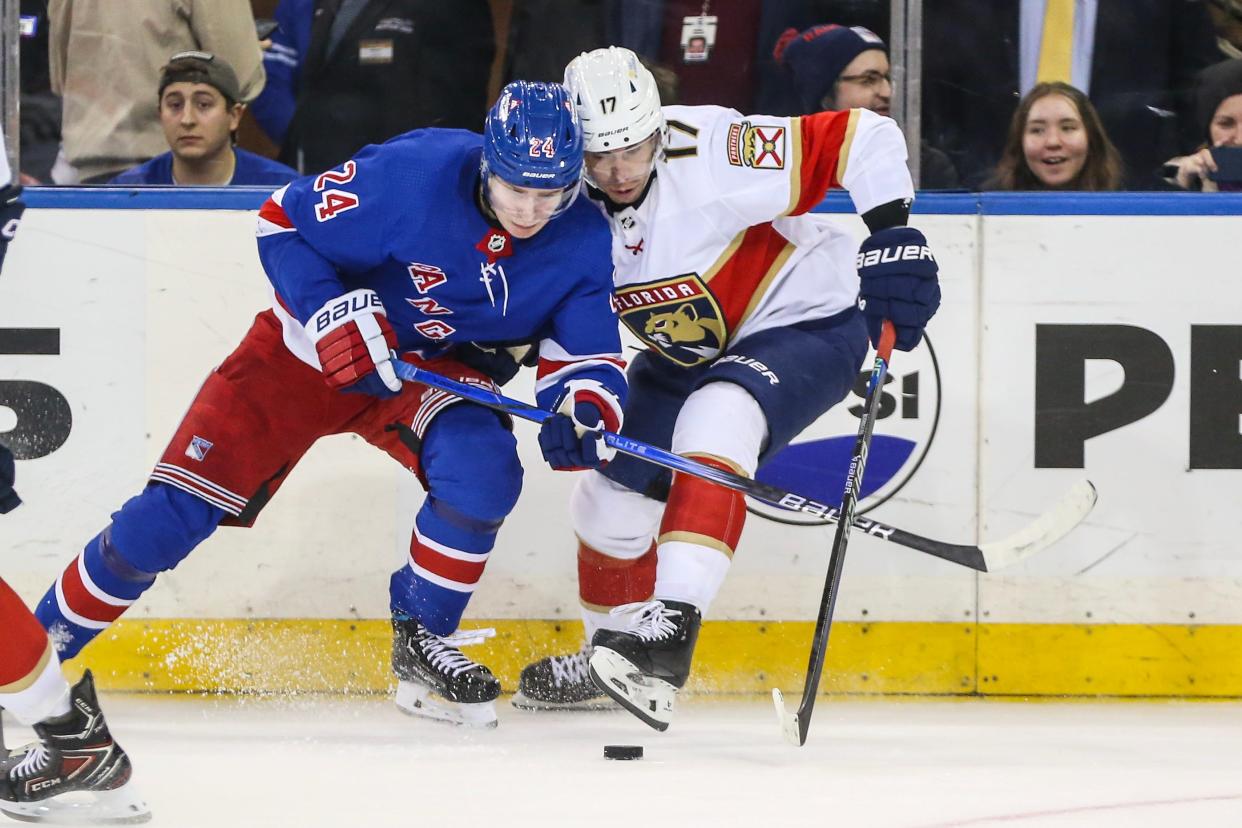 Mar 4, 2024; New York, New York, USA; New York Rangers right wing Kaapo Kakko (24) and Florida Panthers center Evan Rodrigues (17) battle for control of the puck in the third period at Madison Square Garden. Mandatory Credit: Wendell Cruz-USA TODAY Sports