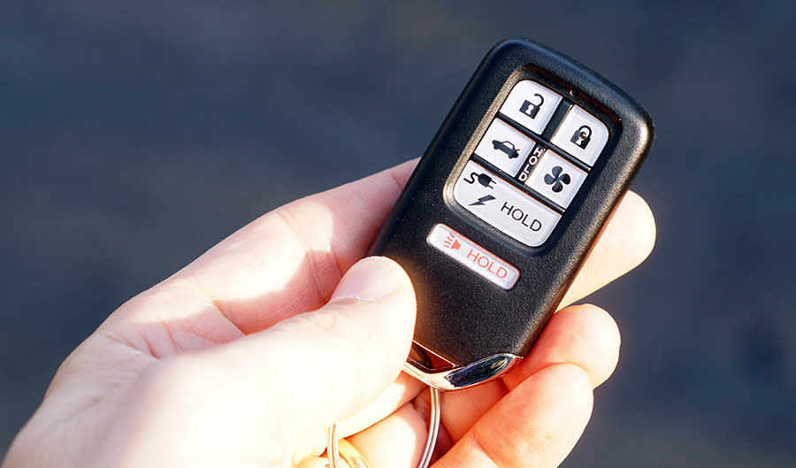 That wide button pops open the electric charging socket; the fan button warms up (or cools down) the car before you get in it.