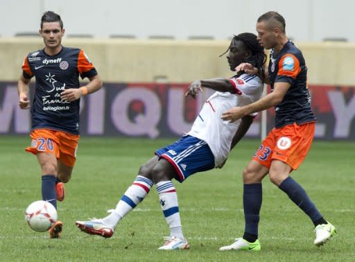 Lyon's Bafetimbi Gomis (C) plays against Montpellier Jamel Saihi (R) and Remy Cabella during the 2012 edition of the Champions Trophy at Red Bull Arena in Harrison, New Jersey. French Cup holders Lyon kicked off the new season by beating title-holders Montpellier on penalties to win the Champions Trophy