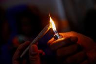 FILE PHOTO: Cannabis entrepreneur Fetti lights a hybrid strain joint of his marijuana brand "PowerPuff" in the Queens borough of New York