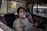 FILE - In this April 24, 2021, file photo, a COVID-19 patient sits in a car and breathes with the help of oxygen provided by a Gurdwara, a Sikh house of worship, in New Delhi, India. Despite clear signs that India was being swamped by another surge of coronavirus infections, Prime Minister Narendra Modi refused to cancel campaign rallies, a major Hindu festival and cricket matches with spectators. The crisis has badly dented Modi’s carefully cultivated image as an able technocrat. (AP Photo/Altaf Qadri, File)