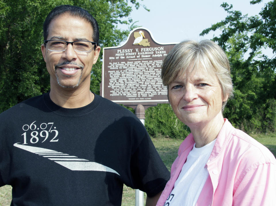 FILE - Keith Plessy and Phoebe Ferguson, descendants of the principals in the Plessy V. Ferguson court case, pose for a photograph in front of a historical marker in New Orleans, on Tuesday, June 7, 2011. Homer Plessy, the namesake of the U.S. Supreme Court’s 1896 “separate but equal” ruling, is being considered for a posthumous pardon. The Creole man of color died with a conviction still on his record for refusing to leave a whites-only train car in New Orleans in 1892. (AP Photo/Bill Haber, File)