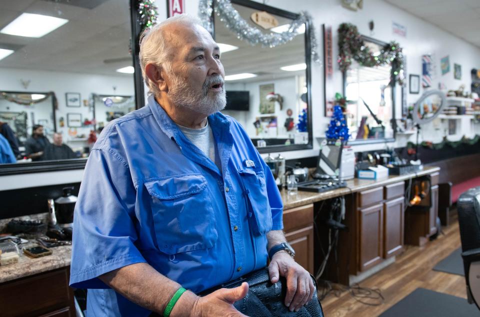 Armando Rodriguez talks about his business and the development along West Nine Mile Road at Armando's Barber Shop on Wednesday, Dec. 6, 2023.