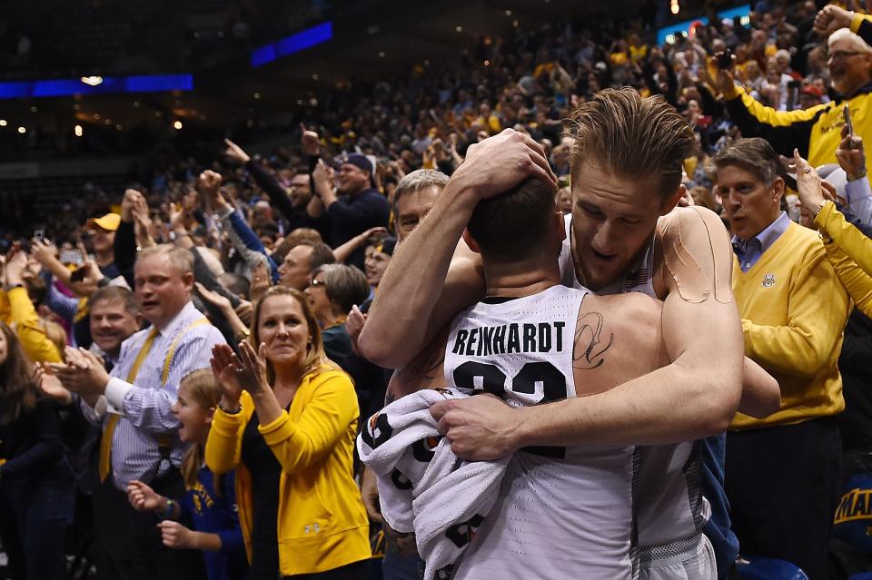 Luke Fischer (40) and Katin Reinhardt (22) of the Marquette Golden Eagles celebrate an upset victory over the Villanova Wildcats at BMO Harris Bradley Center on January 24, 2017 in Milwaukee, Wisconsin.