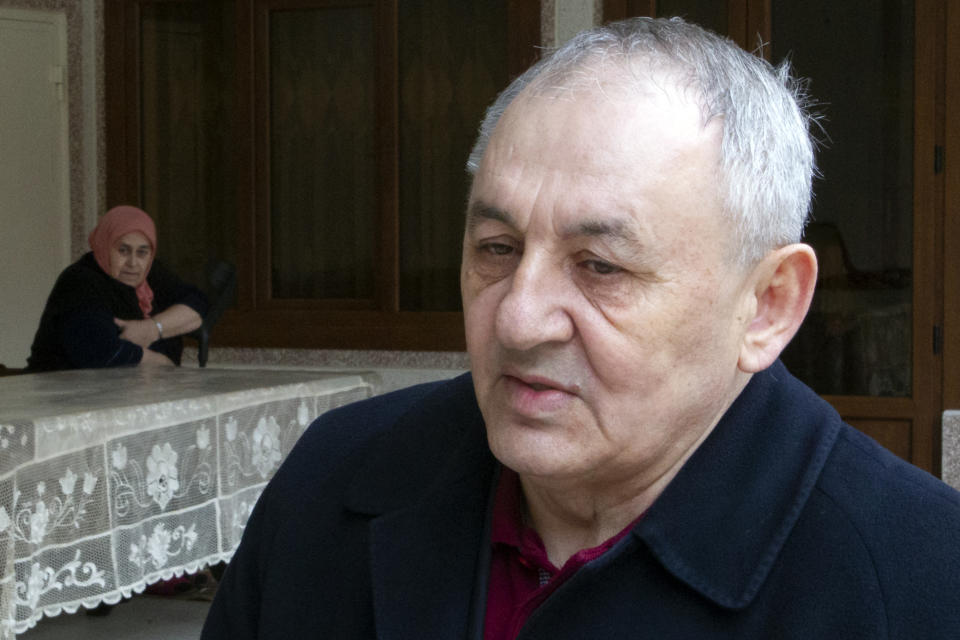In this Sunday, March 17, 2019, photo, Yakub Titiyev, elder brother of jailed activist Oyub Titiyev, speaks to the Associated Press at their family home in Kurchaloy, Chechnya, Russia. A court in Russia's Chechnya is due to issue its verdict Monday, March 18 in the case of the prominent rights activist. (AP Photo/Musa Sadulayev)