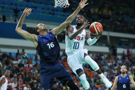 Aug 14, 2016; Rio de Janeiro, Brazil; United States guard Kyrie Irving (10) prepares to shoot the ball as France center Rudy Gobert (16) defends during the men's preliminary round in the Rio 2016 Summer Olympic Games at Carioca Arena 1. Jeff Swinger-USA TODAY Sports