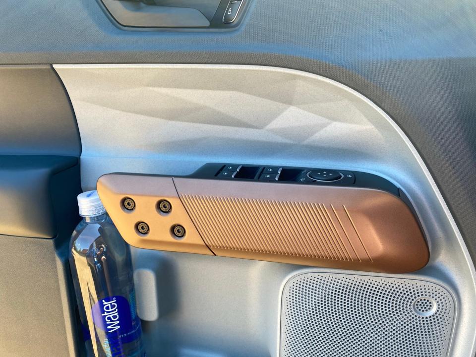 The 2022 Ford Maverick's innovative arm rest  makes room for big bottles.