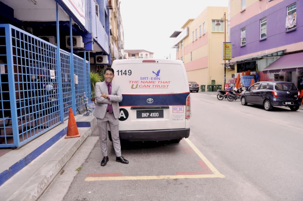 SRT-EON managing director Rafiq Rahmat posing in front of a company van. — Picture courtesy of SRT-EON