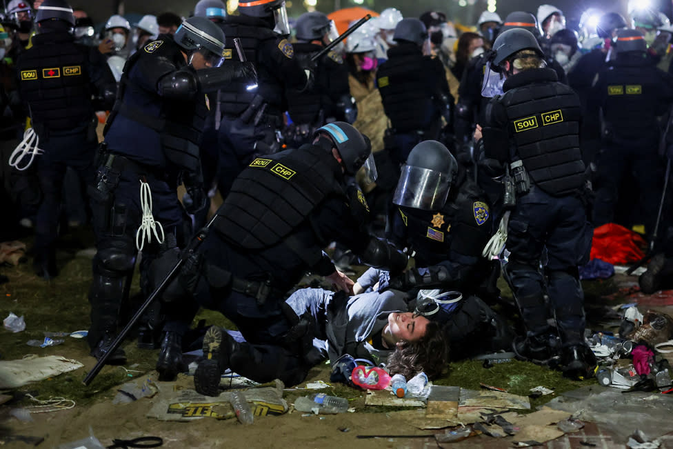 Law enforcement officers detain a protester at the University of California in Los Angeles, during a pro-Palestinian protest, USA, May 2 2024.