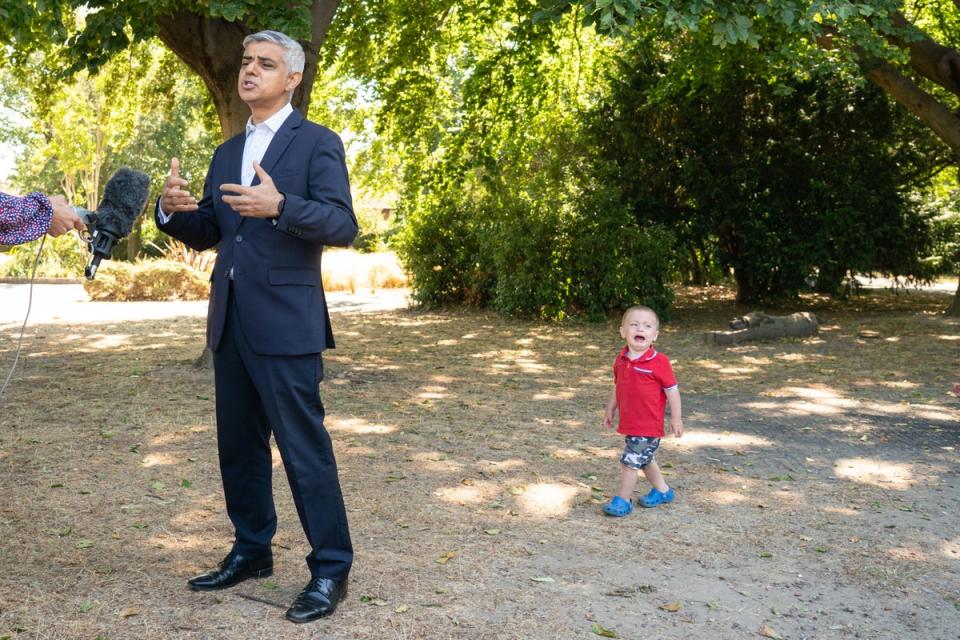 29 July 2022: Maxwell Tall, 2, cries as Mayor of London Sadiq Khan speaks to the media during a visit to Mums for Lungs community group in South Woodford, London, to coincide with the final day of the ULEZ expansion consultation and the publishing of new air quality data (PA)