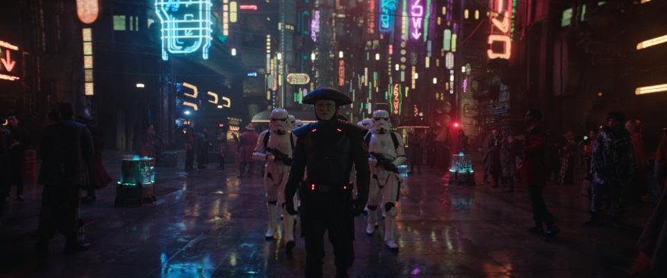 Fifth Brother (Sung Kang) and Imperial Stormtroopers march through neon-lit streets in "Obi-Wan Kenobi."