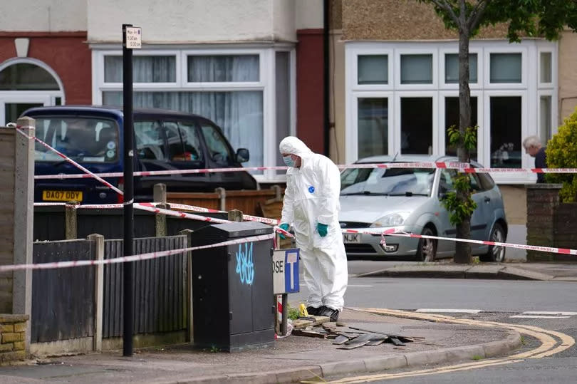 Forensic investigators in Hainault after a 14-year-old boy died after being stabbed and a sword-wielding man arrested following an attack on members of the public and two police officers. Picture date: Tuesday April 30, 2024. PA Photo. See PA story POLICE Hainault. Photo credit should read: Jordan Pettitt/PA Wire