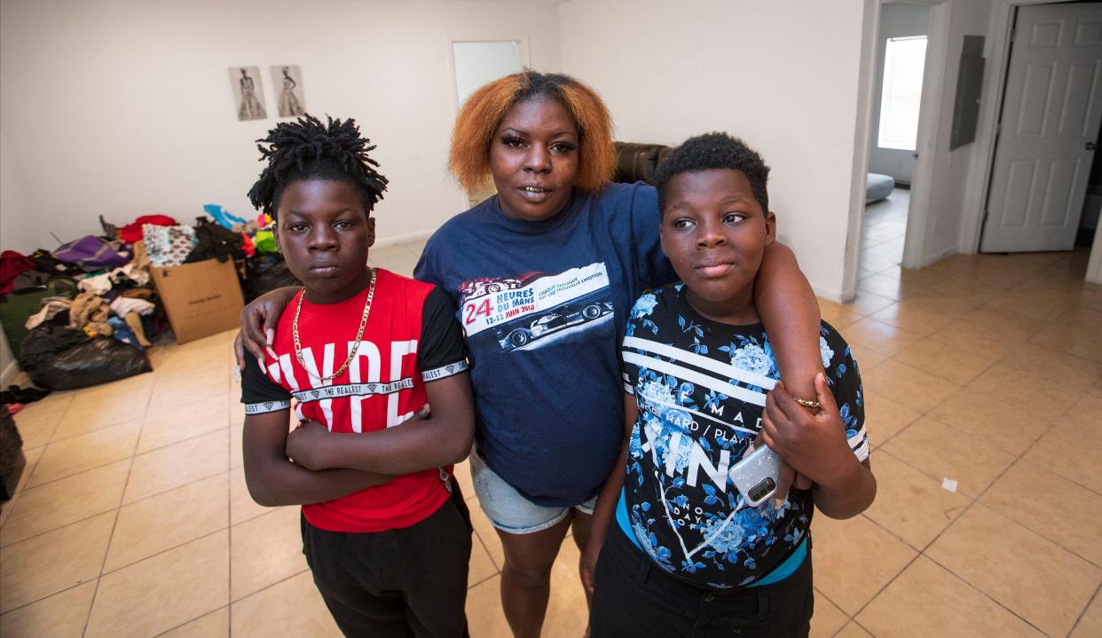 Bernadette Mohorn with her sons Briyon Wohorn,12, (left) and Tyriyon Webster, 9, in their new apartment in Belle Glade Tuesday, March 15, 2022.  They were forced out of a dilapidated apartment building in Pahokee when the county invoked emergency powers to shut the units down, and relocate tenants. Raw sewage was backing up into some of the units, and dangerous electrical systems were in place. Bernadette and Tyriyon are both sick from the mold in the old apartment. 