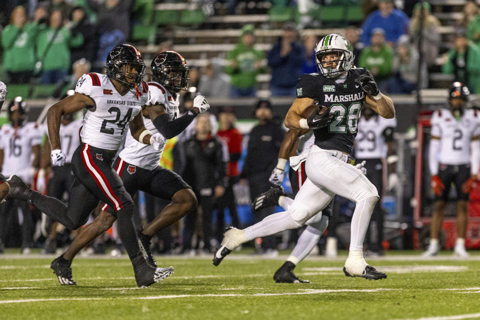 Marshall's Ethan Payne (28) breaks free on a carry against Arkansas State during an NCAA college football game Saturday, Nov. 25, 2023, in Huntington, W.Va. (Sholten Singer/The Herald-Dispatch via AP)