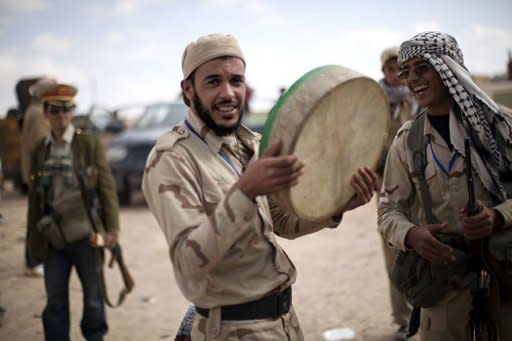 Libyan National Transitional Council (NTC) fighters celebrate in the center of Bani Walid. Libyan fighters raised the new government's flag over the oasis of Bani Walid Monday and hoped for the swift fall of the other remaining redoubt of Moamer Kadhafi loyalists, Sirte, as relatives of his henchmen fled