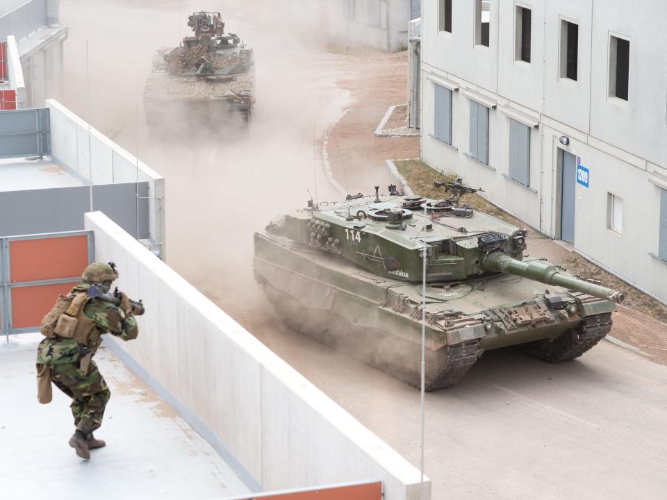 Norwegian Leopard 2 tank leads a CV-90 armored personnel carrier