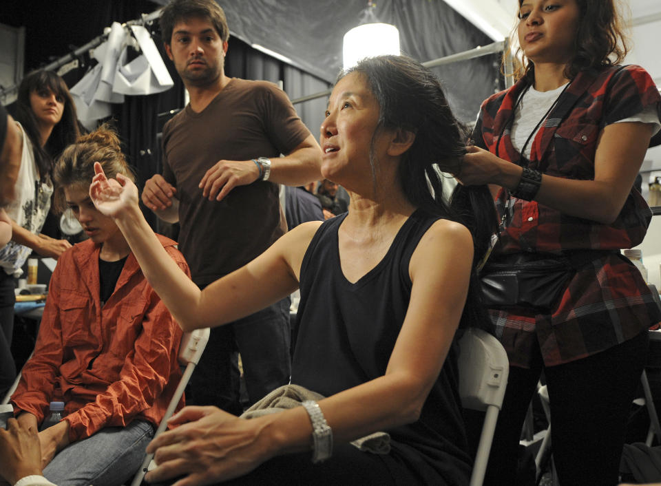 FILE - This Sept. 11, 2008 file photo shows fashion designer Vera Wang getting her hair done backstage before the showing of her spring 2009 collection during Fashion Week in New York. Wang, 63, was honored for her lifetime achievement by the Council of Fashion Designers at its star-studded awards show Monday night. She received the award from her former employer and mentor Ralph Lauren, and she received a standing ovation from her peers. (AP Photo/ Louis Lanzano, file)