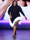 <p>Lizzo shows off her smile while speaking onstage during the Warner Bros. Discovery Upfront 2022 in N.Y.C. on May 18. </p>