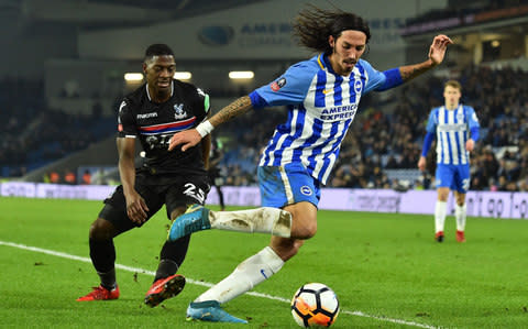 righton's Argentine-born Italian defender Ezequiel Schelotto (r) vies with Crystal Palace's English midfielder Sullay Kaikai during the English FA Cup third round football match between Brighton and Hove Albion and Crystal Palace at the American Express Community Stadium in Brighton, southern England on January 8, 2018 - Credit: AFP