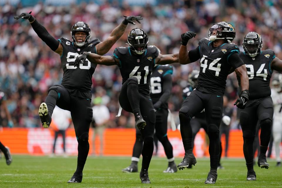 Jacksonville Jaguars defensive end Roy Robertson-Harris (95), Jacksonville Jaguars linebacker Josh Allen (41), and Jacksonville Jaguars linebacker Travon Walker (44) celebrate after a play during an NFL football game between the Atlanta Falcons and the Jacksonville Jaguars at Wembley Stadium in London, Sunday, Oct. 1, 2023. (AP Photo/Steve Luciano)