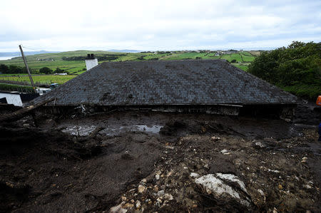 The roof of Bernie Kearney's home is seen, after a landslide carrying a boulder and her car came through the house, during torrential rains in Urris, County Donegal, Ireland August 24, 2017. REUTERS/Clodagh Kilcoyne