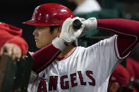 Los Angeles Angels designated hitter Shohei Ohtani (17) warms up in the dugout during the seventh inning of a baseball game against the Oakland Athletics Friday, Sept. 17, 2021, in Anaheim, Calif. (AP Photo/Ashley Landis)