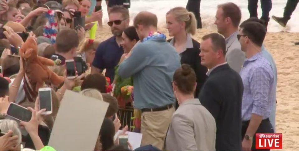 Meghan smiles as she is handed carrots. Photo: Channel 7