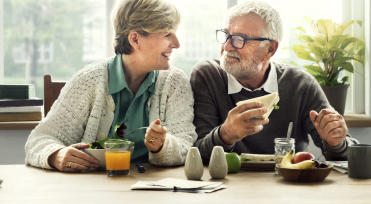 Happily married older couple enjoying a healthy lunch.