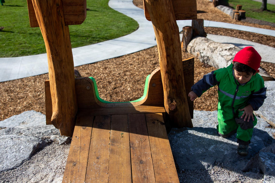 Children play on the new play equipment during the opening of the Sally Smoly Nature Playscape Wednesday, Oct. 27, 2021, at the Window on the Waterfront in Holland. The park made with natural materials, was funded through community donations and the Outdoor Discovery Center. 