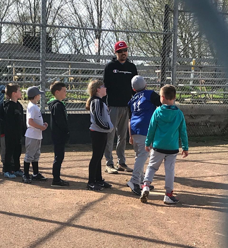 A Cambridge Little League coach prepares his team for the upcoming season at the Cambridge City Park. The Cambridge Little League will hold its Opening Day Celebration on Saturday.