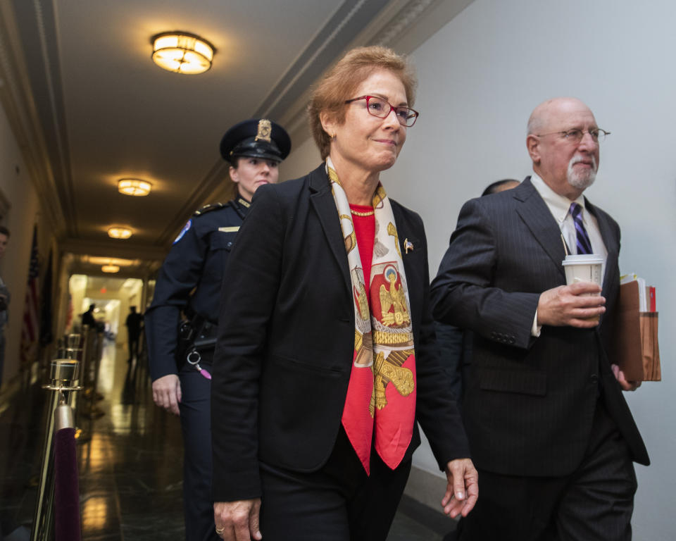 Former U.S. Ambassador to Ukraine Marie Yovanovitch walks back to the hearing room to testify Friday, Nov. 15, 2019, on Capitol Hill in Washington, in the second public impeachment hearing of President Donald Trump's efforts to tie U.S. aid for Ukraine to investigations of his political opponents. (AP Photo/Manuel Balce Ceneta)