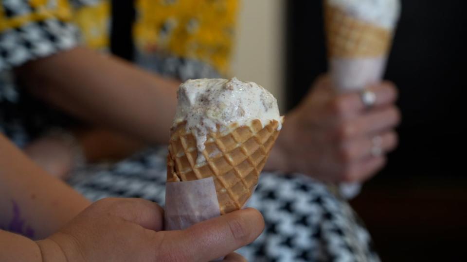 An customer at Village Ice Cream's Victoria Park location holds an ice cream cone on July 9, 2024.