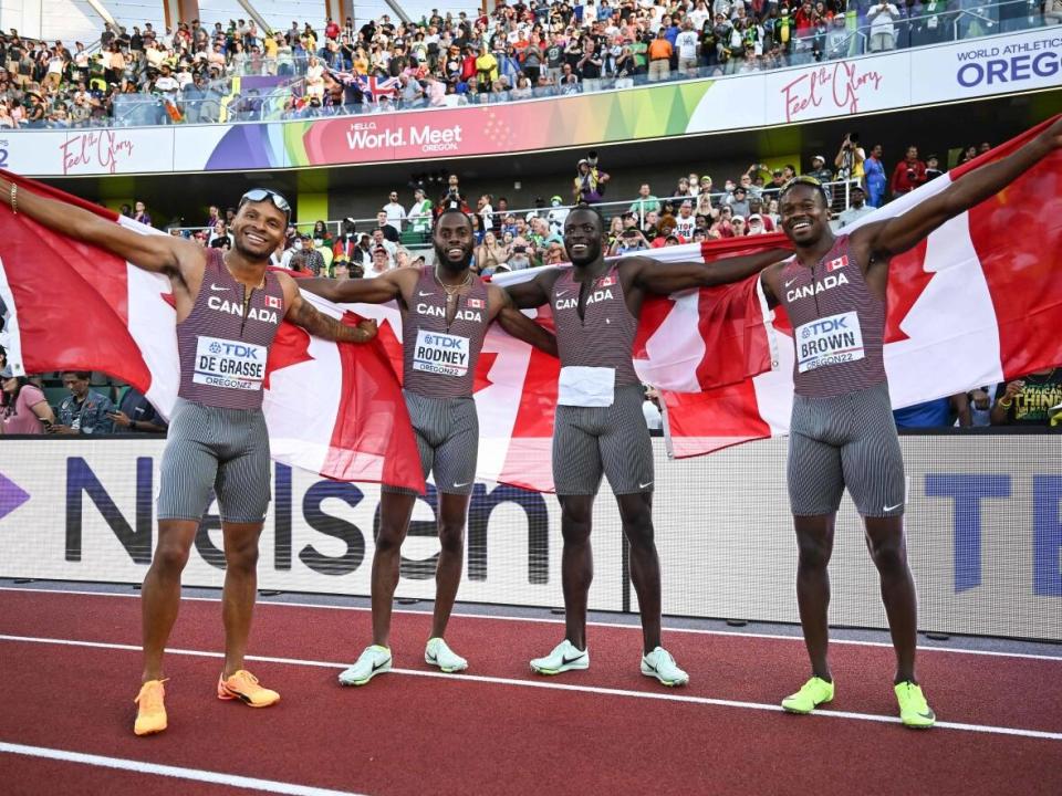 Left to right, Canada's Andre De Grasse, Brendon Rodney, Jerome Blake and Aaron Brown celebrate after winning the men's 4x100m relay T the World Athletics Championships in July. (AFP via Getty Images - image credit)