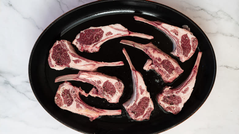 Lamb chops sauteing in a pan