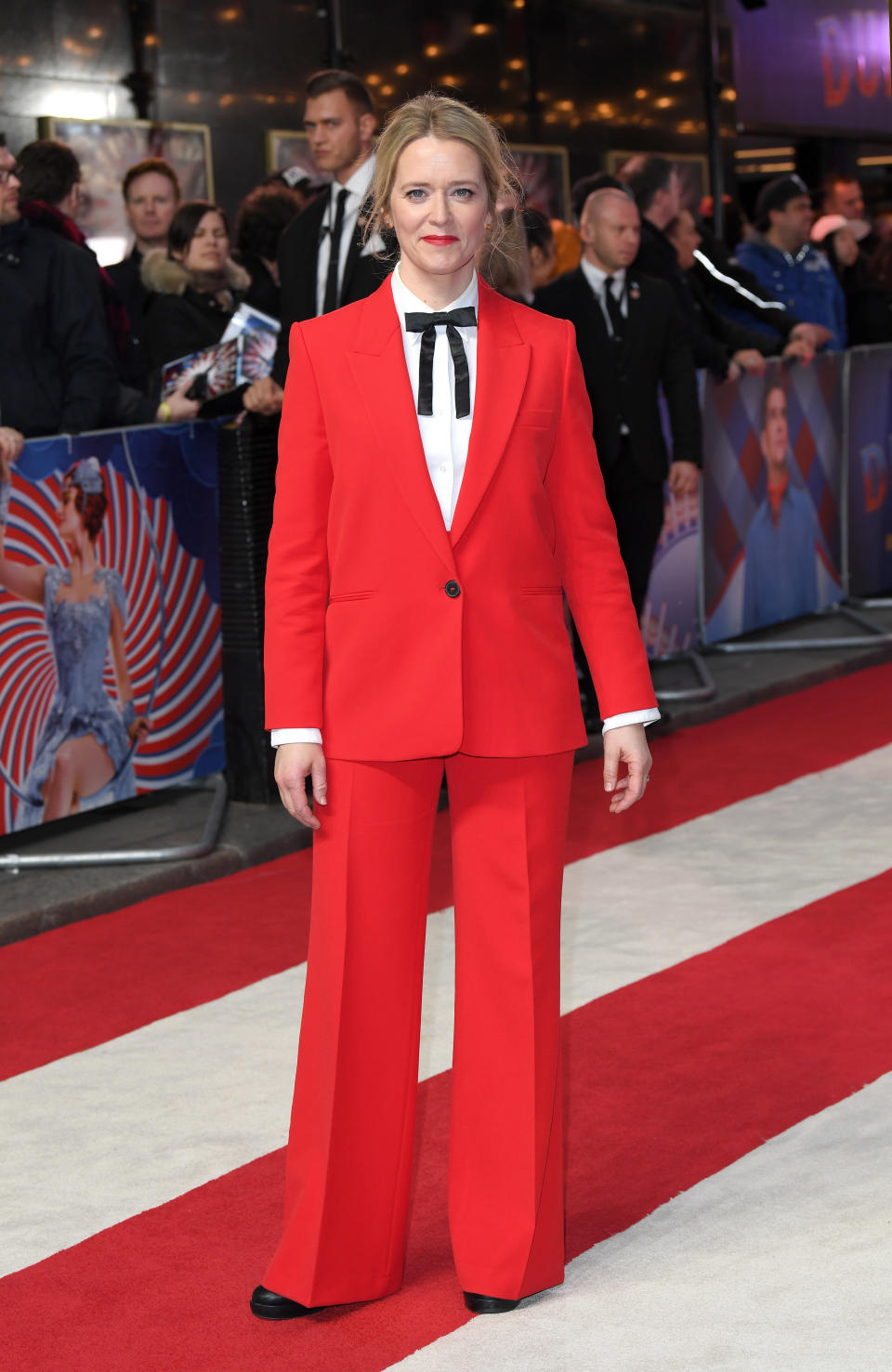 <p>The television presenter wore a red trouser suit, white shirt and black neck tie on the red carpet for the ‘Dumbo’ premiere in London. <em>[Photo: Getty]</em> </p>