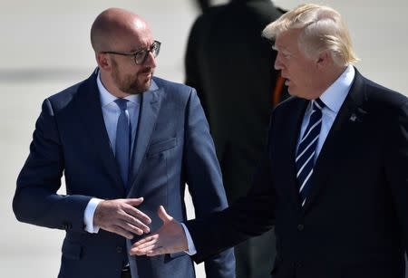U.S. President Donald Trump (R) and Belgian Prime Minister Charles Michel shake hands at the Brussels Airport in Brussels, Belgium, May 24, 2017. REUTERS/Hannah McKay