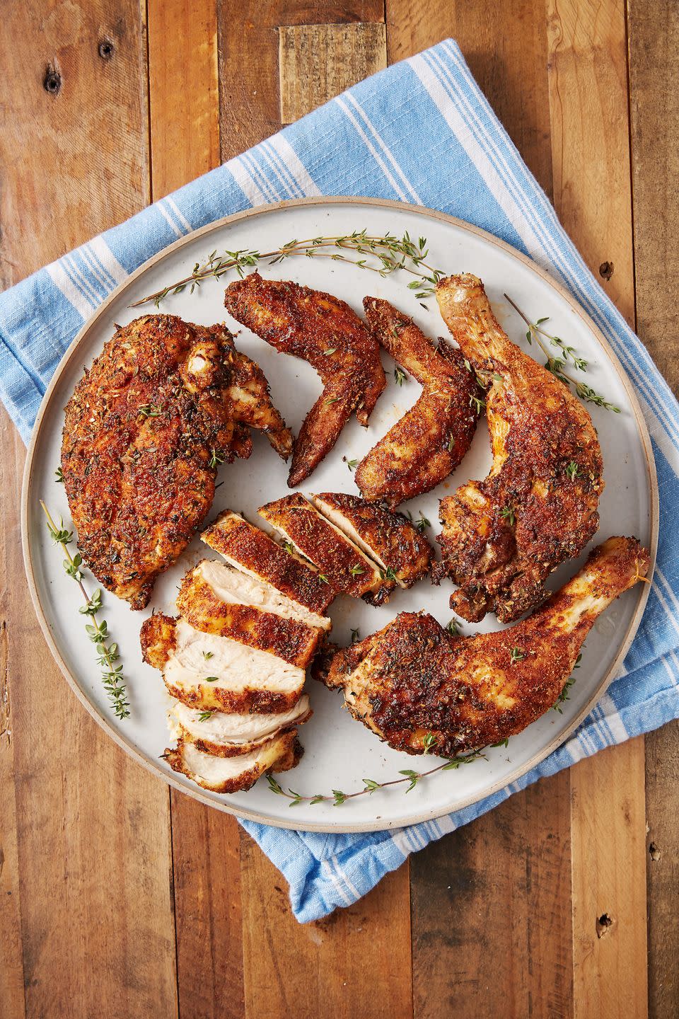 <p>This easy recipe takes most of the waiting out of roasting a chicken, with remarkably similar results. </p><p>Get the recipe from <a href="https://www.delish.com/cooking/recipe-ideas/a28135832/air-fryer-rotisserie-chicken/" rel="nofollow noopener" target="_blank" data-ylk="slk:Delish" class="link ">Delish</a>.</p>