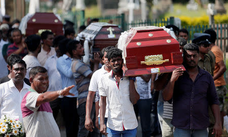 Coffins of victims are carried during a mass for victims, two days after a string of suicide bomb attacks on churches and luxury hotels across the island on Easter Sunday, in Colombo, Sri Lanka April 23, 2019. REUTERS/Dinuka Liyanawatte