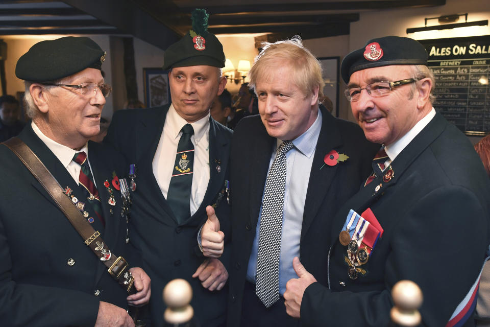 Britain' Prime Minister Boris Johnson meets with military veterans at the Lych Gate Tavern in Wolverhampton, England, Monday, Nov. 11, 2019 as part of the General Election campaign trail. Britain goes to the polls on Dec. 12. (Ben Stansall/Pool Photo via AP)