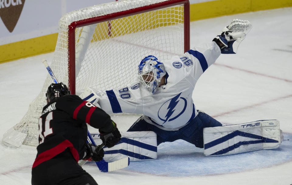 Tampa Bay Lightning goaltender Matt Tomkins unsuccessfully reaches to block a shot from Ottawa Senators right wing Vladimir Tarasenko as he scores during first period of an NHL hockey game, in Ottawa, Ontario, Sunday, Oct. 15, 2023. (Adrian Wyld/The Canadian Press via AP)