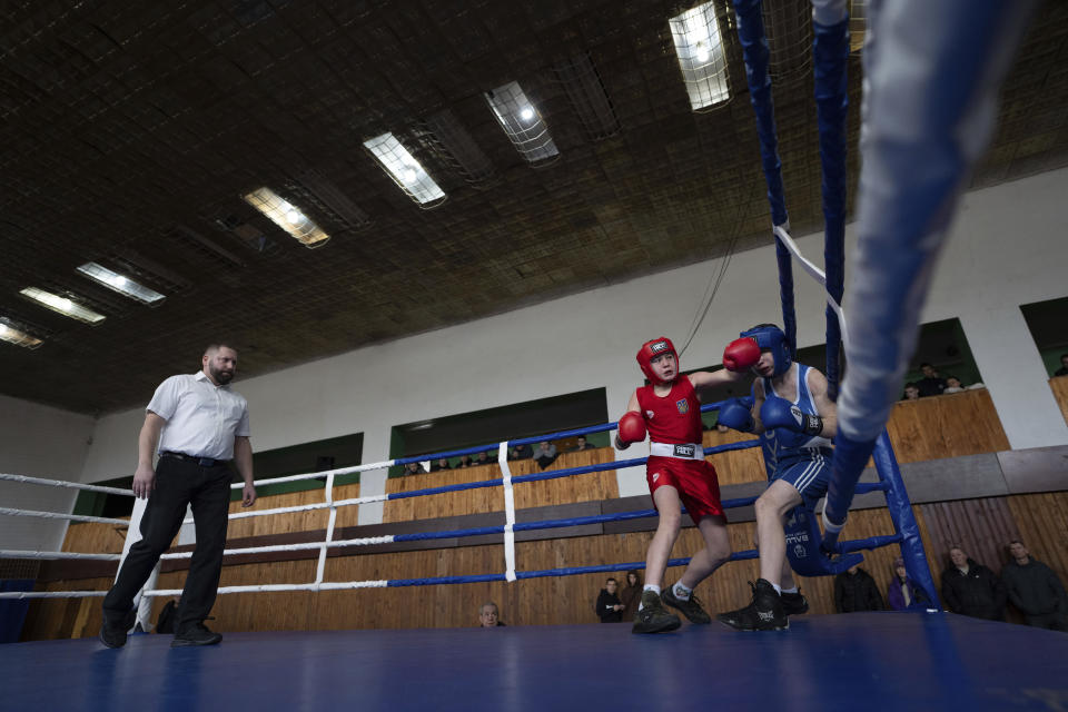 Young boxers fight during a boxing tournament in honor of Maksym Halinichev, who was killed during fighting with Russian forces in March 2023, in Romny, Sumy region, Ukraine on Sunday, Feb. 4, 2024. (AP Photo/Evgeniy Maloletka)