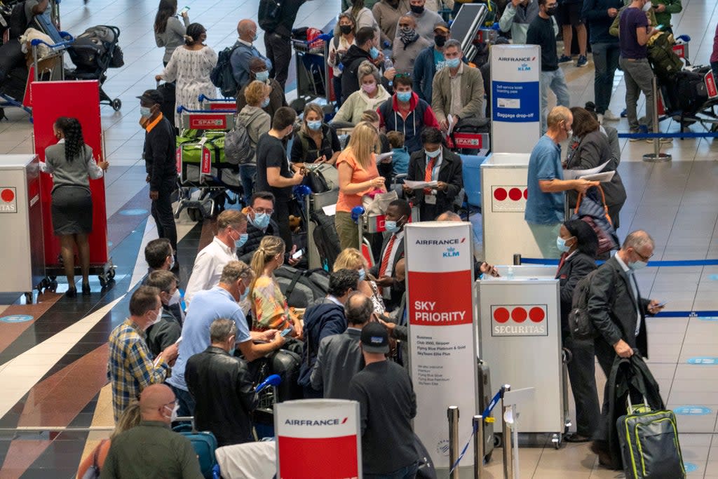 People line up to get on the Air France flight to Paris at OR Tambo International Airport in Johannesburg, South Africa, Friday Nov. 26, 2021.   (AP)