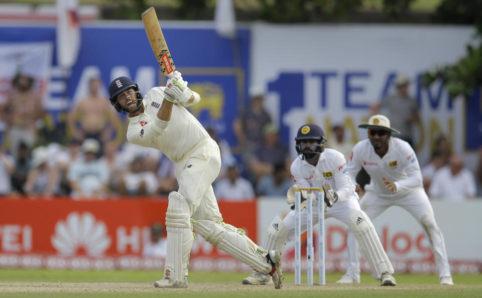 England's Ben Foakes plays a shot as Sri Lankan wicketkeeper Niroshan Dickwella and Dimuth Karunaratne watch during the third day of the first test cricket match between Sri Lanka and England in Galle, Sri Lanka, Thursday, Nov. 8, 2018. (AP Photo/Eranga Jayawardena)