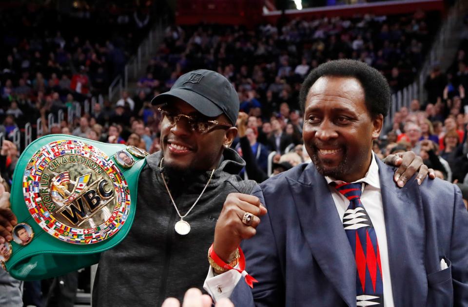 FILE- World Boxing Council's Junior Middleweight champion Tony Harrison, left, stands with former boxer Thomas "The Hitman" Hearns during the second half of an NBA basketball game between the Detroit Pistons and the Utah Jazz, Saturday, Jan. 5, 2019, in Detroit. Harrison (29-3-1, 21 KOs) is fighting Australian Tim Tszyu (21-0, 15-0 KOs) on Sunday, March 12, 2023, in Sydney for the vacant WBO 154-pound title. (AP Photo/Carlos Osorio, File)