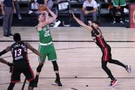 Miami Heat's Bam Adebayo (13) and Tyler Herro, right, defend as Boston Celtics forward Gordon Hayward (20) attempts a shot during the second half of an NBA conference final playoff basketball game, Saturday, Sept. 19, 2020, in Lake Buena Vista, Fla. (AP Photo/Mark J. Terrill)