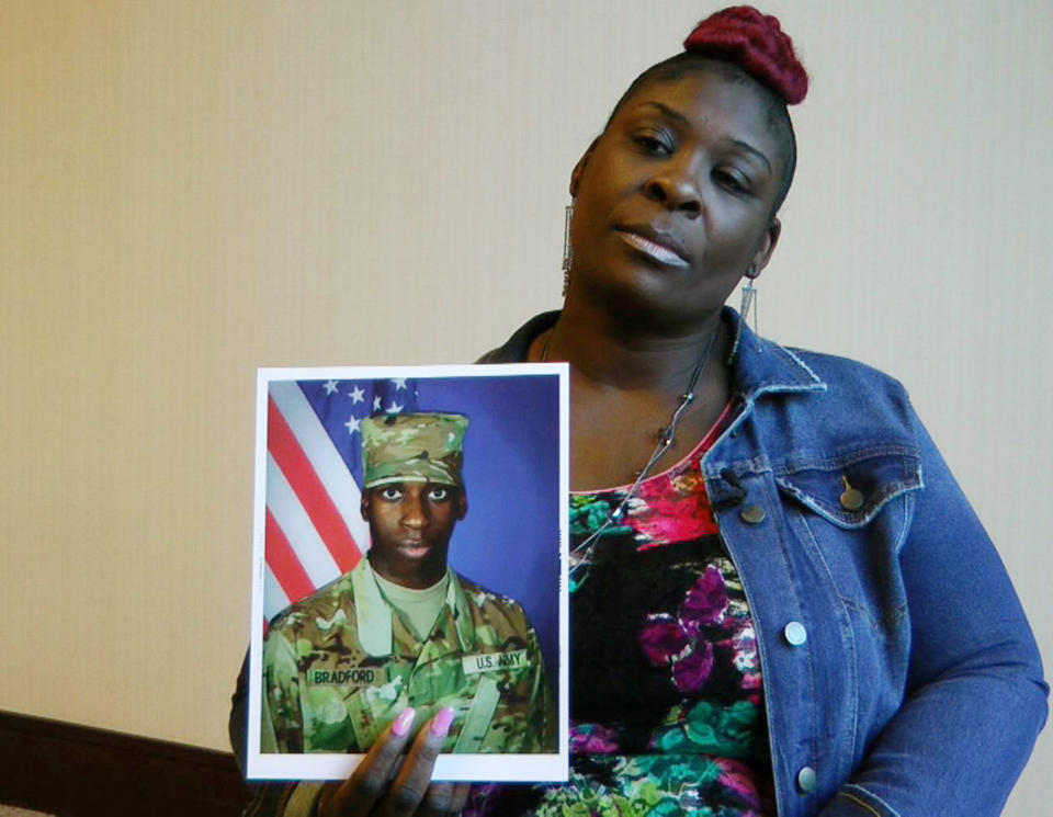 FILE - In this Nov. 27, 2018, file frame from video, April Pipkins holds a photograph of her deceased son, Emantic "EJ" Bradford Jr., during an interview in Birmingham, Ala. A police officer will not face charges for killing Bradford Jr, a man he mistook for the gunman in an Alabama mall shooting on Thanksgiving night. Alabama Attorney General Steve Marshall announced Tuesday, Feb. 5, 2019, that he concluded the officer did not break the law and won’t be charged in the death. (AP Photo/Jay Reeves, File)